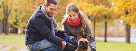 young couple with dog in park