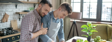 Gay couple cooking dinner