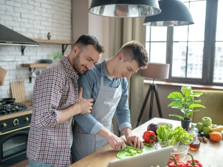 Gay couple cooking dinner