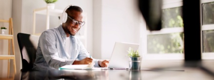 man at desk with headphones on