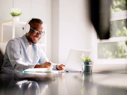 man at desk with headphones on