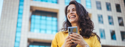 woman in yellow coat on phone