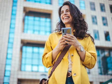 woman in yellow coat on phone