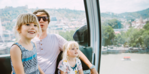 father and two daughters in a cable car