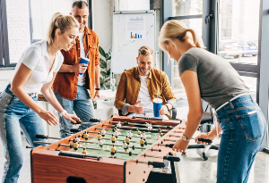 colleagues playing table football