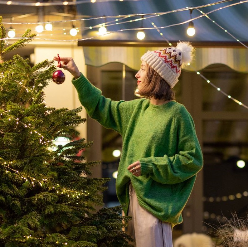 Woman decorating Christmas tree