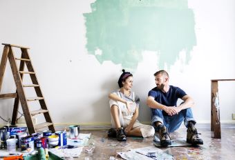 Couple painting a wall