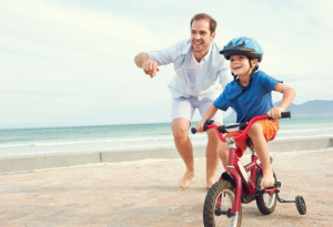 Father teaching son to ride a bike