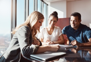 female financial advisor giving advice to a couple