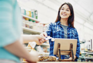 Woman in shop paying for goods