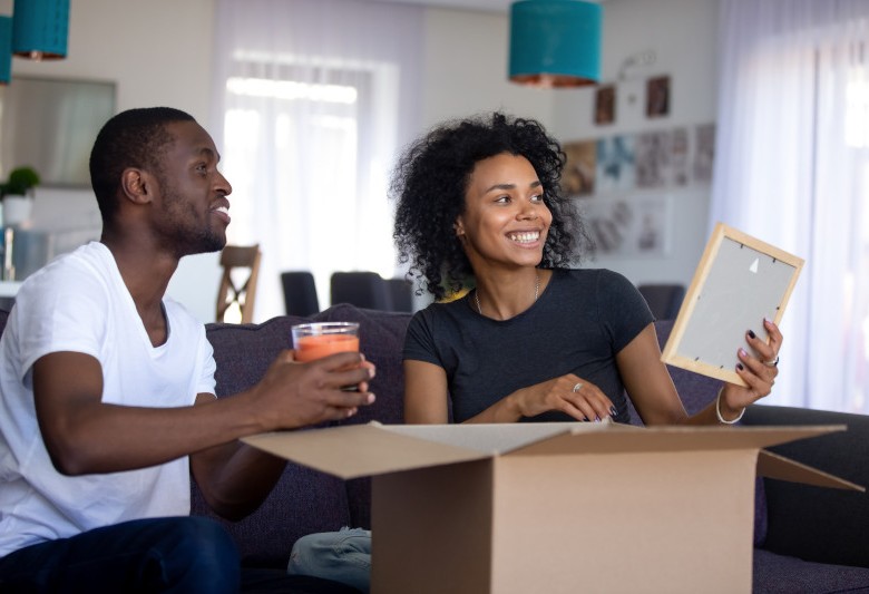 Man and woman at home unpacking boxes