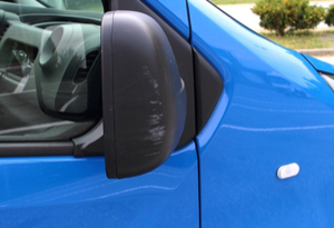 blue van with wing mirror damage